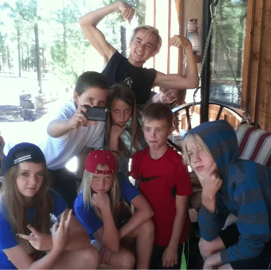 Grandkids goofing around on the ranch porch during summer