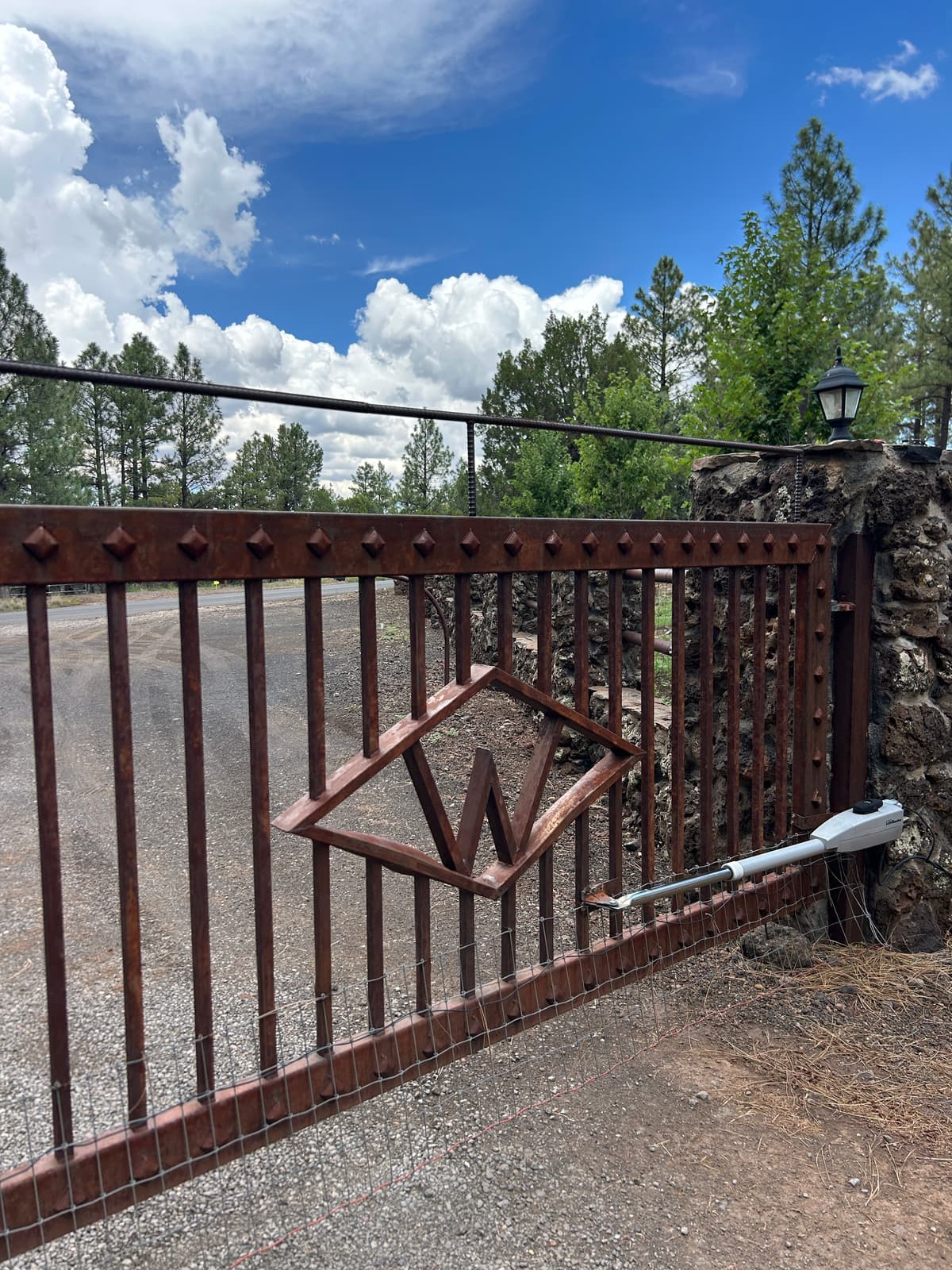 The Diamond W entrance gate with the brand logo