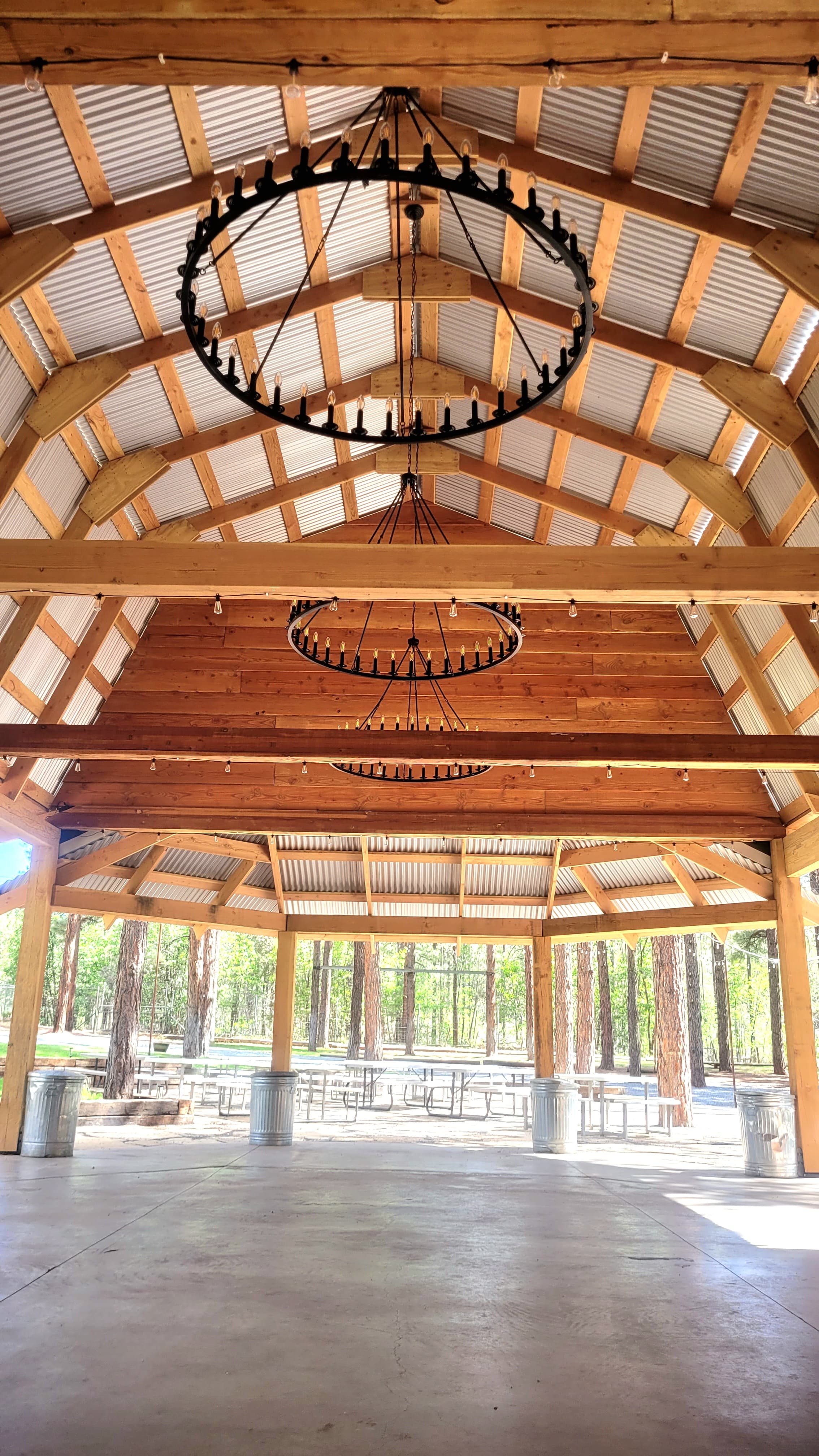 Vaulted ceiling of the ramada with two large iron wagon-wheel chandeliers